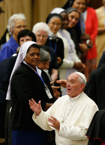 Pope Francis greets a nun during an audience with the heads of women's religious orders in Paul VI hall at the Vatican May 12. During a question-and-answer session, the pope said he was willing to establish a commission to study whether women could serve as deacons. (CNS/L'Osservatore Romano)