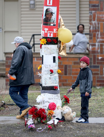 People walk by a memorial to Jamar Clark March 30 in Minneapolis, where Clark was shot by police in November 2015. (Newscom/ZUMA Press/The Star Tribune/David Joles)