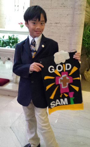 Sam Butler celebrates his first Communion at St. Gertrude Parish in Chicago May 7.