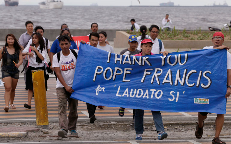 Environmental activists march toward a Roman Catholic church to celebrate the release of Laudato Si', Pope Francis' encyclical on the environment, June 18, 2015, in Manila, Philippines. (AP Photo/Bullit Marquez)