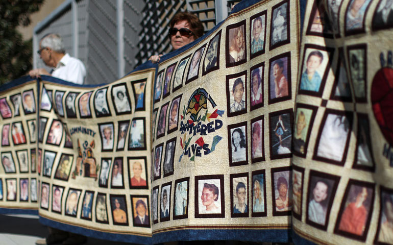 People hold quilts at a February 2013 press conference outside of Cathedral of Our Lady of the Angels for victims of sexual abuse by priests in the Los Angeles archdiocese. (Newscom/Reuters/David McNew)