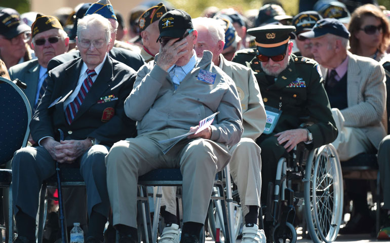 World War II veterans attend a joint French-U.S. ceremony at the Normandy American Cemetery and Memorial in Colleville-sur-Mer, France, June 6, marking the 70th anniversary of D-Day. (AFP/Getty Images/Damien Meyer)