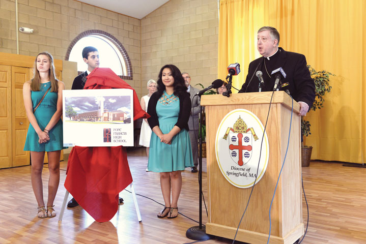 Bishop Mitchell Rozanski of Springfield, Mass., announces the new Pope Francis High School June 19. An artist's drawing of the new school is posted at left with three high school students. (The Republican/Mark M. Murray)