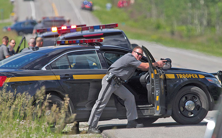 Law enforcement personnel search along Route 30 in Malone, N.Y., after cornering two escaped prisoners on June 26. (Newscom/UPI/Matthew Healey)