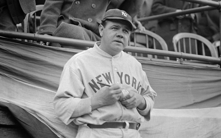 Babe Ruth autographs a baseball during the 1924 season, three years before he set the home run record of 60 as a member of the New York Yankees. (AP/Corbis/© Bettmann)