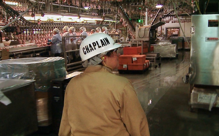 Tyson Foods Chaplain Melissa Brannan walks the production line at a food processing plant in Springdale, Ark. (Journey Films)