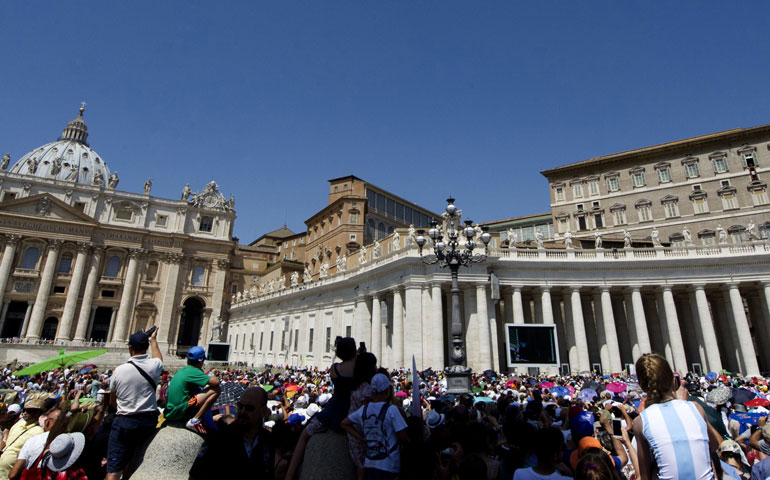 People listen to Pope Francis giving the Angelus prayer from the window of the apartments at St. Peter’s Square Aug. 4 at the Vatican. (AFP/Getty/Tiziana Fabi)