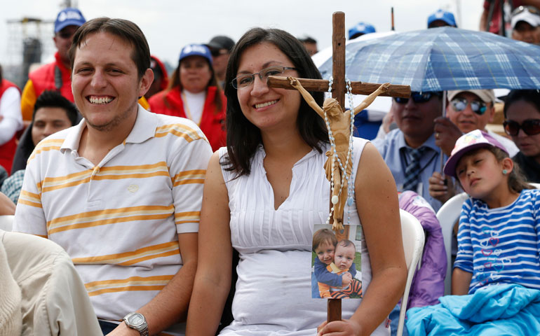 Family members attend Pope Francis' celebration of Mass in Bicentennial Park in Quito, Ecuador, July 7. (CNS/Paul Haring)