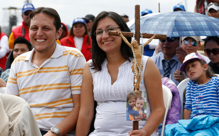 Family members attend Pope Francis' celebration of Mass in Bicentennial Park in Quito, Ecuador, July 7. (CNS/Paul Haring)