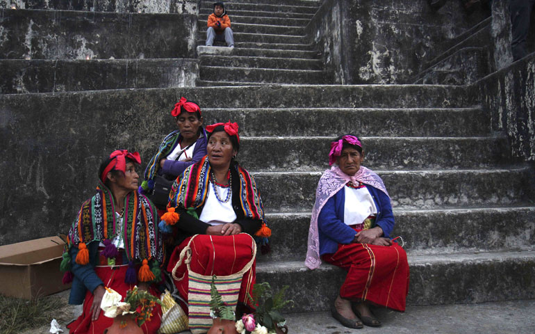 Women get ready to take part in a Mayan ceremony at the Zaculeu archaeological site in Huehuetenango, Guatemala, Dec. 21, 2012. (Newscom/ZUMA Press/STR)
