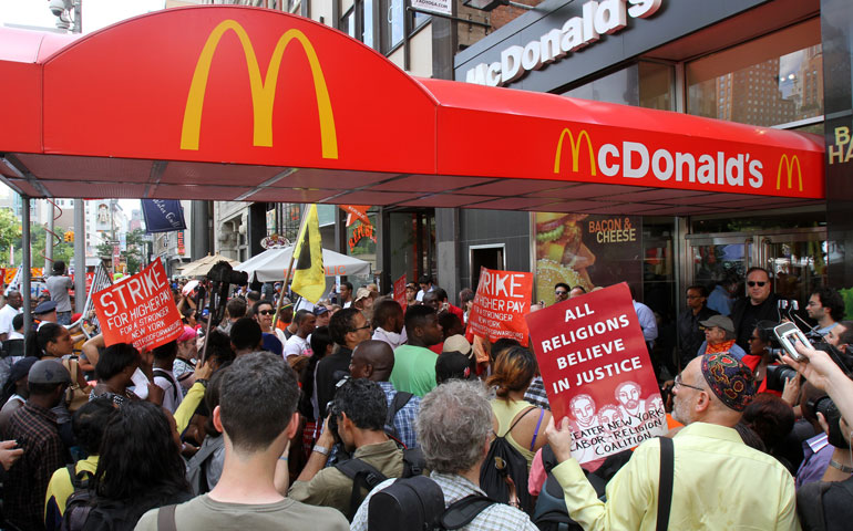 Fast-food workers and their supporters rally in front of a McDonald’s restaurant in New York’s Union Square as they demand higher wages July 29. (CNS/Gregory A. Shemitz)