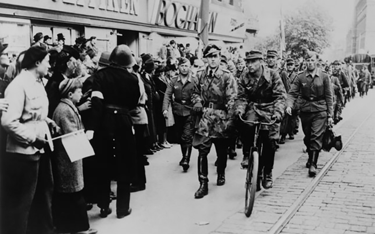 Nazi soldiers march down a commercial street in German-occupied Denmark in 1945. Denmark was one of the last occupied countries to be cleared of Germans, waiting until May 5, 1945, for liberation by the British army. (Newscom/Everett Collection)