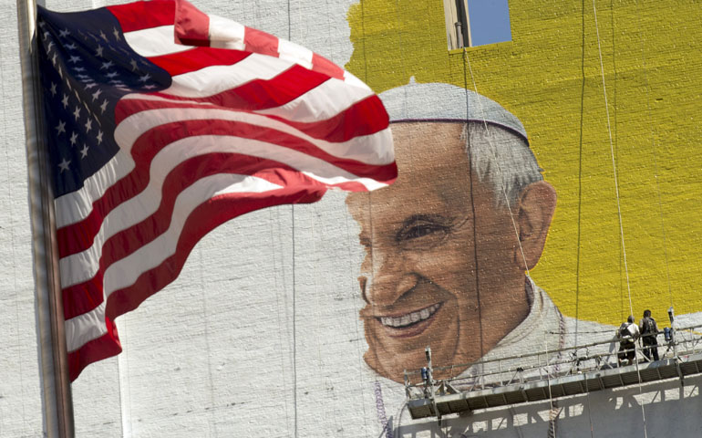 On Aug. 28, workers paint a 220-foot-tall mural on Eighth Avenue in New York announcing the visit of Pope Francis to the city Sept. 22. (Newscom/Polaris/Jonathan Sciortino)
