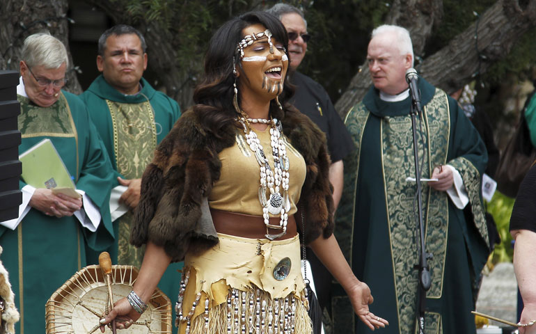 A member of the Costanoan Rumsen Carmel Tribe of the Ohlone Nation sings while commemorating Founder’s Day at the Carmel Mission in California June  28. The mission was founded by Junípero Serra in 1771. (Newscom/Reuters/Michael Fiala)