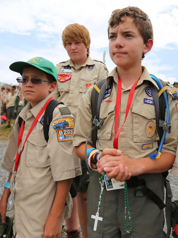 John Jarboe, 13, of Tulsa, Okla., holds his rosary during Mass at the National Boy Scout Jamboree at Summit Bechtel Family National Scout Reserve in Mount Hope, W.Va., July 21. (CNS/Courtesy of Boy Scouts of America/Al Drago)