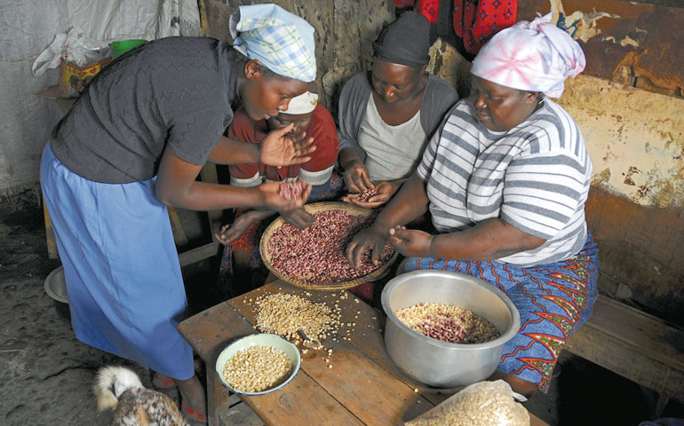Women sort beans and maize kernels in a house in Mukuru, a slum in Nairobi, Kenya, in 2012. (AP Images/Corbis/Wendy Stone)