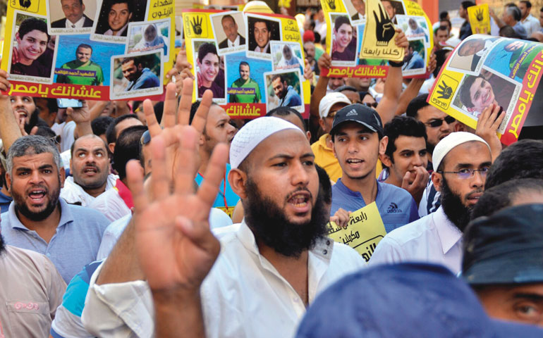 Egyptians supporters of ousted President Mohamed Morsi take part in a protest called by the Muslim Brotherhood in Cairo Aug. 30. (Newscom/EPA/Mostafa Darwish)