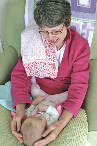 After another orthopedic surgery, Teresa Rhodes McGee recovers by listening to her grandniece Harper Grace.