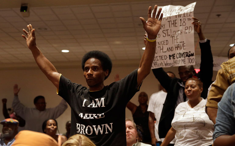 Larry Miller holds up his hands after speaking during a public comments portion of a City Council meeting Sept. 9 in Ferguson, Mo. (AP Photo/Jeff Roberson)