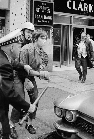 Two policemen arrest a member of the Weathermen during an Oct. 11, 1969, march in the downtown Chicago area. (AP/Fred Jewell)