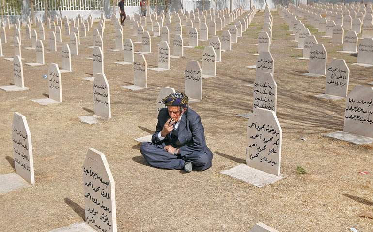 On March 16, an Iraqi Kurd visits the cemetery for victims of the 1988 chemical attack in Halabja, Iraq. (Newscom/Reuters/Thaier al-Sudani)