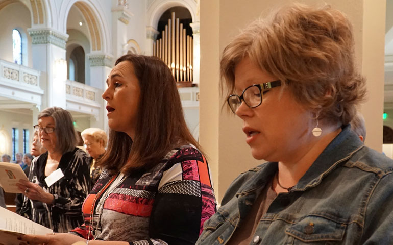Jonna O'Bryan, foreground, and Carrie Williamson of St. Patrick Church in Louisville, Ky., sing Oct. 9 during the closing liturgy of the "Women of the Church" conference in Ferdinand, Ind. (CNS/The Record/Marnie McAllister)