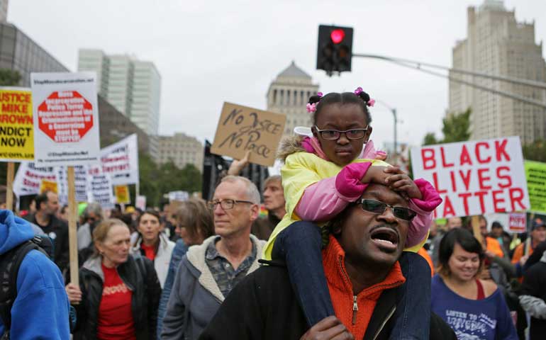 Darnell Taylor marches with his daughter, Lauren, 4, in St. Louis Oct. 11 as part of Ferguson October demonstrations. (Newscom/Polaris/St. Louis Post-Dispatch/Cristina Fletes-Boutte)