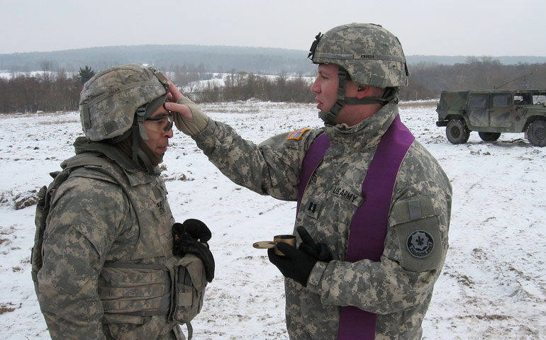 Army chaplain Fr. Christopher Butera administers ashes to soldiers training in the field on Ash Wednesday 2013. (CNS/Courtesy of Fr. Christopher Butera)
