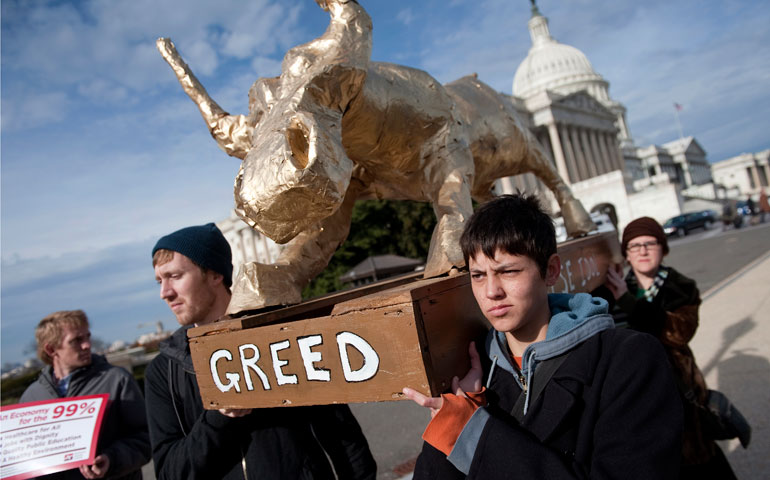 Occupy Faith D.C. attempts to deliver a "golden calf" in the shape of the Wall Street bull to House Speaker John Boehner's office in December 2011. (Newscom/CQ-Roll Call/Chris Maddaloni)