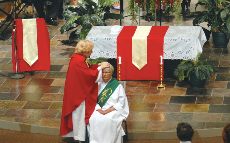 Bishop Bridget Mary Meehan lays hands on Deacon Diane Dougherty during the ordination Mass Oct. 20 at First Metropolitan Community Church in Atlanta. (Mary Waxmonsky)