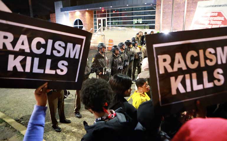 Protesters gather in front of the police station Oct. 11 in Ferguson, Mo. (AP Photo/St. Louis Post-Dispatch/Christian Gooden)