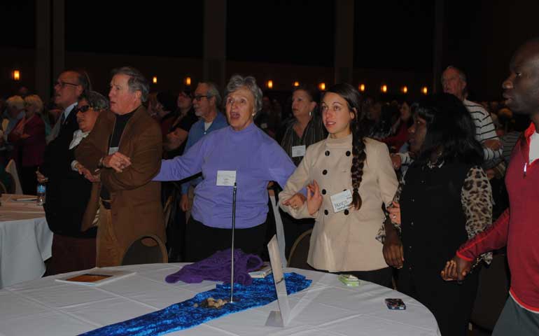 During the opening program of Call to Action's 2014 National Conference, audience members sing along with the LeMoyne-Owen College choir's performance of "We Shall Overcome" in Memphis, Tenn., Nov. 7.