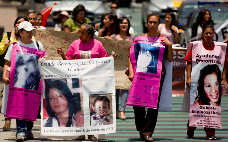 In Mexico City June 18, mothers carry posters of their daughters who disappeared in Ciudad Juárez. The marchers were demanding police investigate the cases of missing women in the border area. (AP Photo/Eduardo Verdugo)