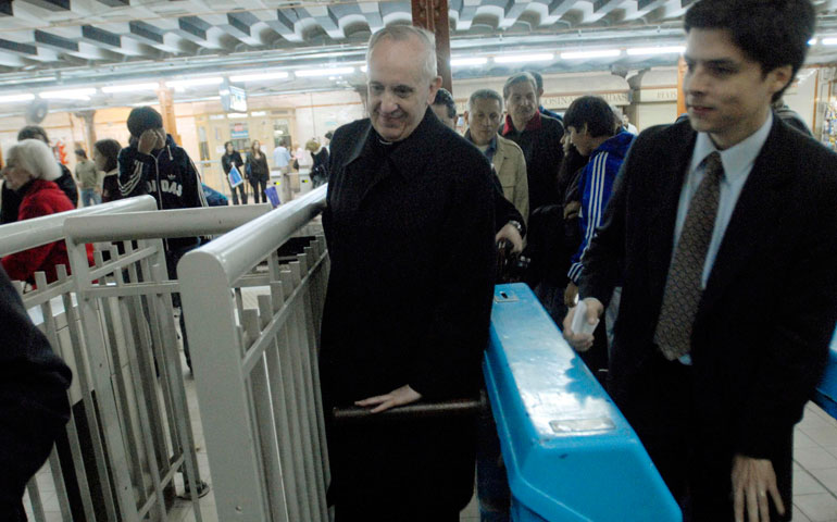 Argentine Cardinal Jorge Mario Bergoglio, now Pope Francis, walks through a subway turnstile in Buenos Aires in 2008. (CNS/Clarin handout via Reuters/Diego Fernandez Otero)