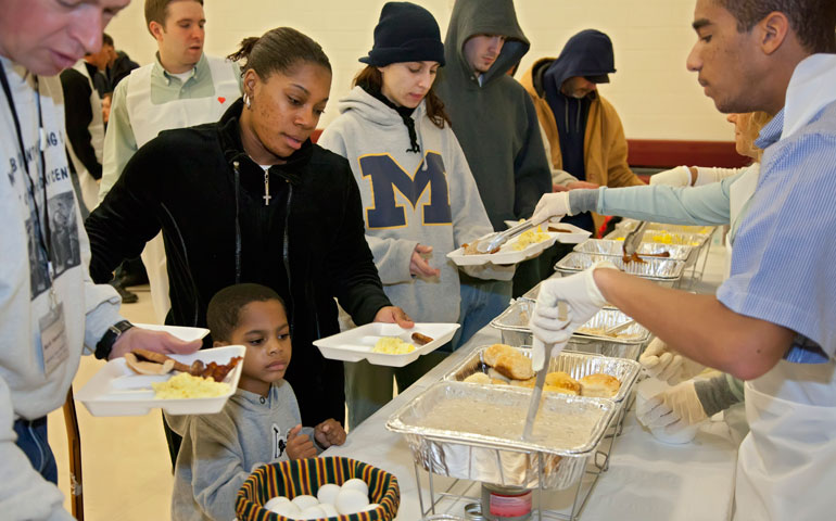 Volunteers serve breakfast to the needy at a shelter in Mount Clemens, Mich., in 2011. (CNS/Jim West)