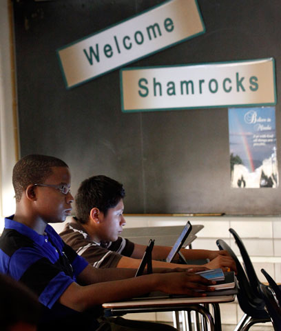 Freshmen Brendon Stewart and Aldo Oliver read from Apple iPads during religion class at St. Patrick High School in Chicago Aug. 29. (CNS/Catholic New World/Karen Callaway)