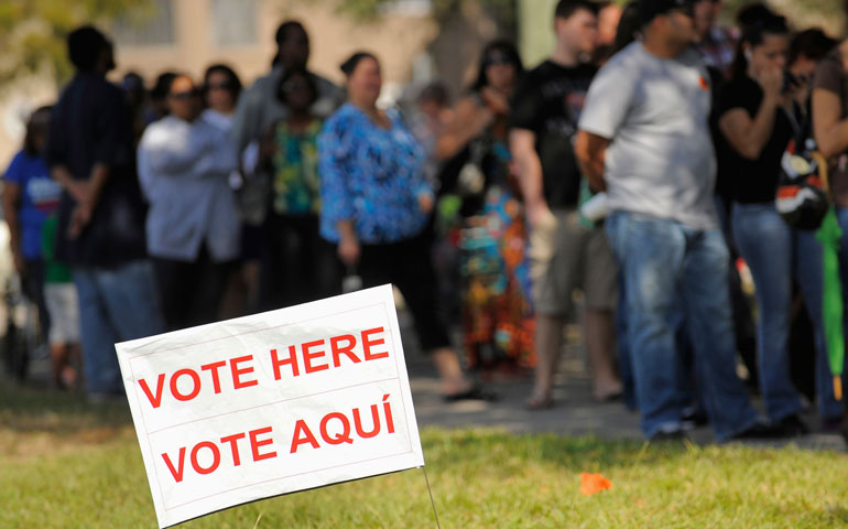 A sign in English and Spanish is seen outside a polling place in Kissimmee, Fla., Nov. 6. (CNS/Reuters/Scott A. Miller)