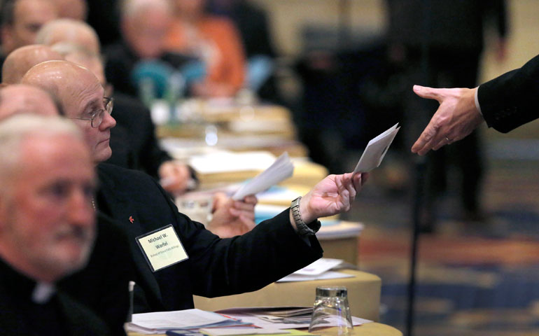 Bishop Michael Warfel of Great Falls-Billings, Mont., turns in his paper ballot during the 2015 fall general assembly of the U.S. Conference of Catholic Bishops in Baltimore Nov. 17. (CNS/Bob Roller)
