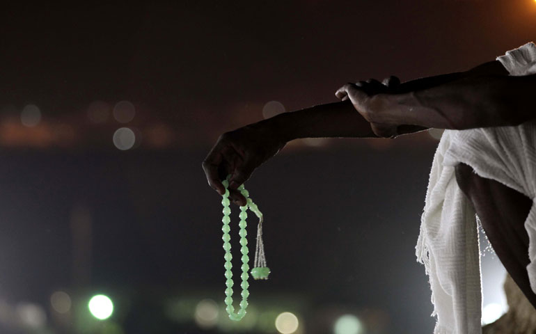 Muslim pilgrims pray atop Mount Mercy on the plains of Arafat Oct. 3, 2014, during the annual Hajj pilgrimage, near the holy city of Mecca, Saudi Arabia. (Newscom/APAImages/Polaris/Ashraf Amra)