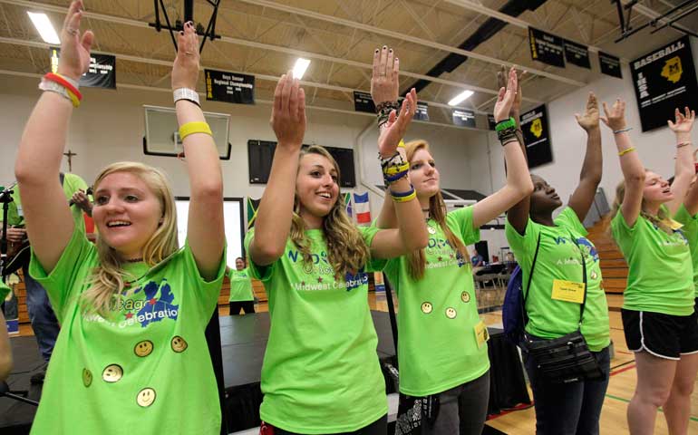 Participants join in the World Youth Day theme song as more than 700 Catholic teens and young adults from the Chicago archdiocese and other Midwest dioceses gather for “WYD Chicago: A Midwest Celebration” at Marian Catholic High School in Chicago Heights, Ill., July 27, 2013. (CNS/Catholic New World/Karen Callaway)