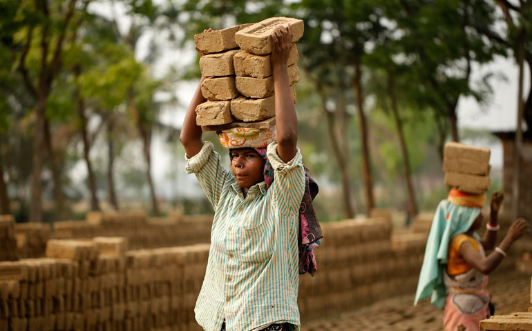 Women carry bricks on their heads in Hobiganj, Bangladesh, March 25, 2015. (CNS/EPA/Abir Abdullah)