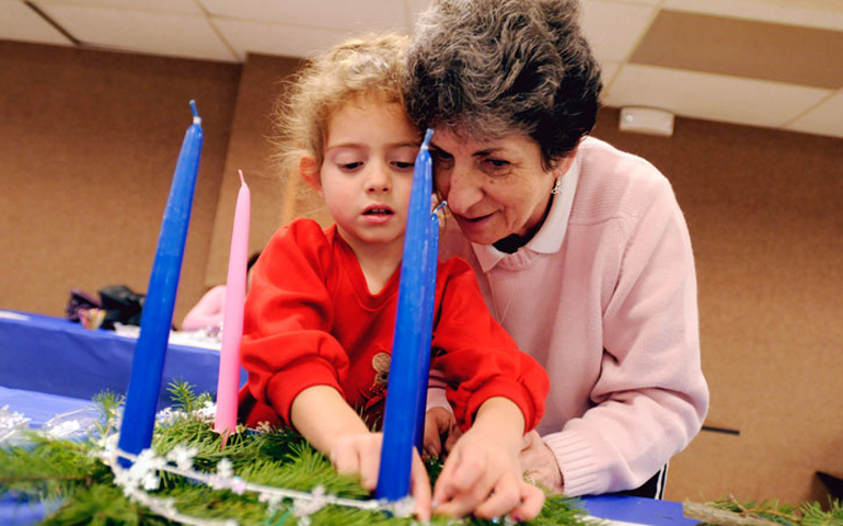 Four-year-old Olivia Morey and her grandmother Cecelia Lester make an Advent wreath during a 2008 Advent activity party at St. Charles Borromeo Church in Greece, N.Y. Advent began Nov. 27 this year. (CNS/Catholic Courier/Mike Crupi)