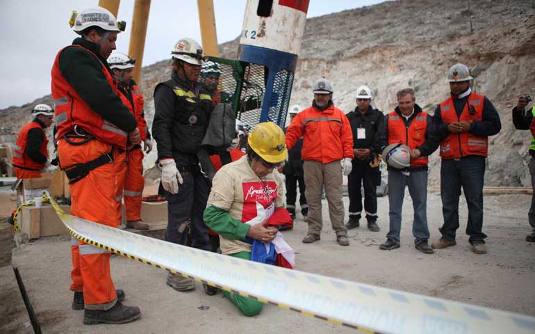 Miner Mario Gómez, 63, the oldest of the 33 trapped miners, prays as he arrives on the surface after being rescued in Copiapó, Chile, Oct. 13, 2010. (CNS/Reuters/Hugo Infante-Government of Chile)