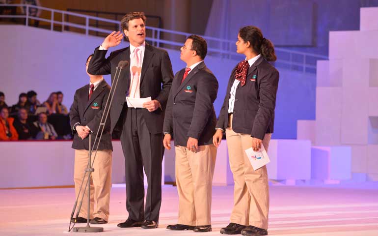 Timothy Shriver listens for the reply to his question, "Athletes, will you lead us?", during the Jan. 29, 2013, opening ceremony of the Special Olympics Winter Games in Pyeongchang, South Korea. (Will Schermerhorn)