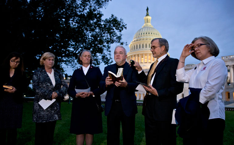 Religious leaders representing the "Circle of Protection" pray at the Capitol Oct. 16 in Washington. (AP Photo/J. Scott Applewhite)