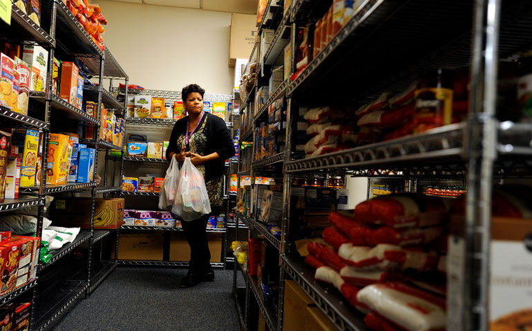 Monica Post gets groceries for a needy client in late November in the pantry of the Catholic Family Center in Rochester, N.Y. (CNS/Catholic Courier/Mike Crupi)