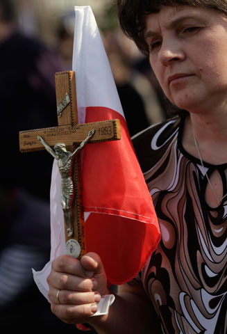 A woman attends a Mass before a march in Warsaw, Poland, April 21, to protest the denial of a broadcast license for the Catholic Trwam TV station. (CNS/Reuters/Kacper Pempel)
