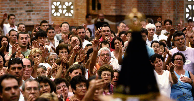 Worshipers pray in the Basilica of the National Shrine of Our Lady Aparecida in 2007 in Brazil. The conference of Latin American bishops, or CELAM, held a major meeting in Aparecida that year. (CNS/Reuters/Paulo Whitaker)