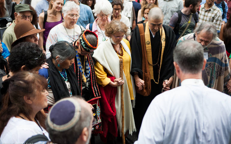 Faith leaders unite in a prayer circle to open the People's Climate March September 21. Faith groups joined the 300,000 people participants in seeking global solutions to climate change. (Emma Cassidy/People's Climate March)