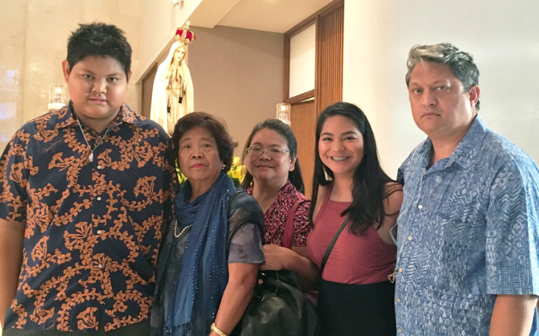 The Kaahaaina family, including Luke (left), stands before the International Pilgrim Virgin Statue of Our Lady of Fatima during its stop at the Co-Cathedral of St. Theresa of the Child Jesus in Honolulu. (Courtesy of the Kaahaaina family)
